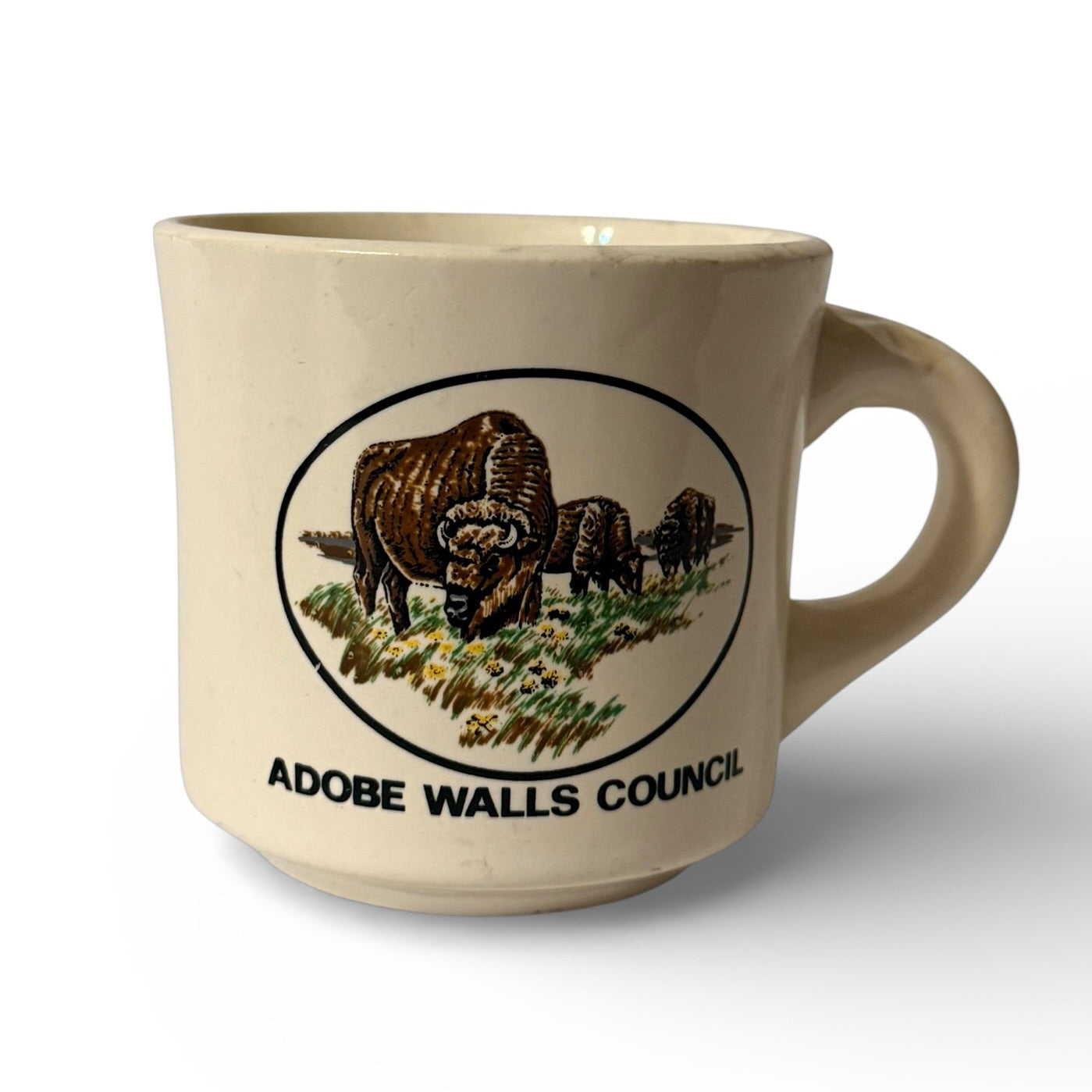 Beige mug with bison design and 'Adobe Walls Council' text on a white background